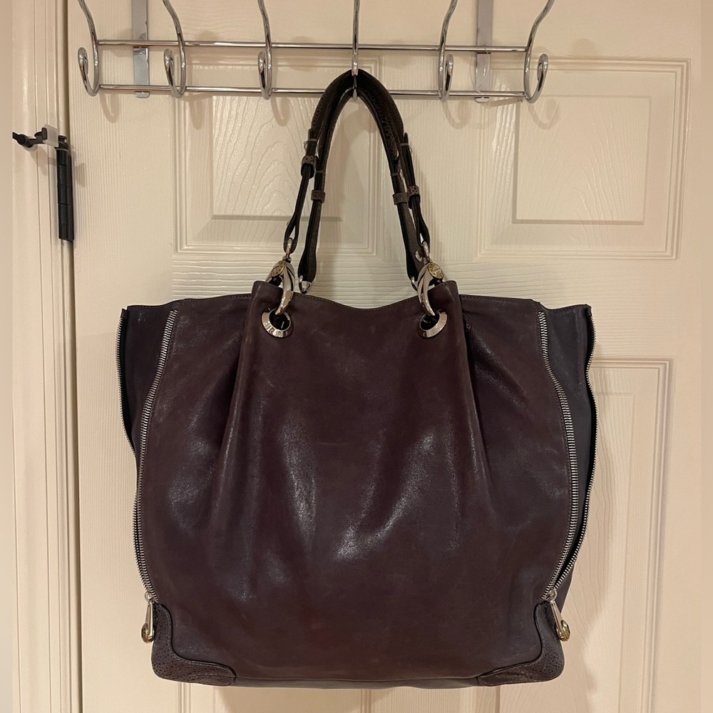 Purple leather, Henri Bendel handbag that expands and has hardware.